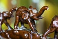 Closeup of small clay elephant figures under the lights with a blurry background Royalty Free Stock Photo