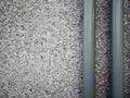 Closeup of Small crushed gravel texture mixed with cement for wall, Decorated with gray pipes, Texture space for text design. Royalty Free Stock Photo
