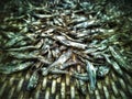 Closeup of small dried fish on a bamboo woven tray background.