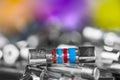 Closeup of small electrical fuses pile on blurry background with colored and white bokeh Royalty Free Stock Photo