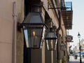 Closeup of small glass gas lanterns on the side of a building on the French Quarter in New Orleans Royalty Free Stock Photo