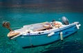 Closeup of small motorboat at clear water bay of Loutro town on Crete island, Greece