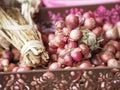 Small onion in a bunch, placed in a brown plastic basket