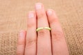 Closeup of a small plastic ring on the middle finger of a person under the lights Royalty Free Stock Photo