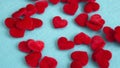 Closeup of small red soft hearts on blue table