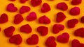 Closeup of small red soft hearts on yellow table
