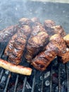 Closeup of small sausages on the grill with smoke and horseradish. Mici Royalty Free Stock Photo