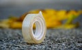 Closeup of a small scotch tape on an asphalt