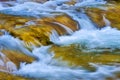 small waterfall on mountain river rushing through the mountain canyon Royalty Free Stock Photo