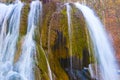 Small waterfall on mountain river rushing through the mountain canyon Royalty Free Stock Photo