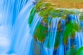 Small waterfall on mountain river rushing through the mountain canyon Royalty Free Stock Photo