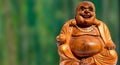 Closeup of a small wooden statue of Buddha of Happiness with a blurry background Royalty Free Stock Photo