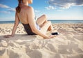 Closeup on smartphone in hand of woman on beach on seashore Royalty Free Stock Photo