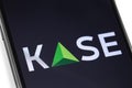 Smartphone and KASE black logo on the screen. KASE, Kazakhstan Stock Exchange - a stock exchange headquartered in Almaty.