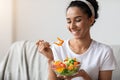 Closeup of beautiful young woman eating healthy salad Royalty Free Stock Photo