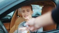 Closeup woman receiving car keys to new vehicle. Businesswoman sitting in car Royalty Free Stock Photo