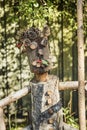 Closeup of a smiling character, possibly a farmer, made of wooden trunks and cones bears happiness and lightheartedness feeling