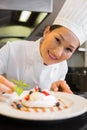 Closeup of a smiling chef garnishing food Royalty Free Stock Photo