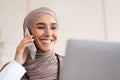 Closeup of female doctor having phone call, using laptop Royalty Free Stock Photo