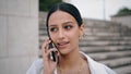 Closeup smiling girl calling phone at staircase. Happy woman talking smartphone Royalty Free Stock Photo