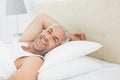 Closeup of a smiling mature man resting in bed