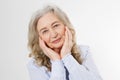 Closeup of smiling senior woman wrinkle face and gray hair. Old mature lady touching her wrinkled skin isolated on white Royalty Free Stock Photo