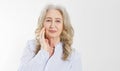 Closeup of smiling senior woman wrinkle face and gray hair. Old mature lady touching her wrinkled skin isolated on white Royalty Free Stock Photo