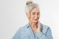 Closeup of smiling senior woman wrinkle face and gray hair. Old mature lady touching her wrinkled skin on white