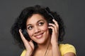 Closeup of a smiling woman listening music looking up Royalty Free Stock Photo