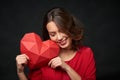 Smiling woman holding red polygonal heart shape Royalty Free Stock Photo
