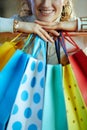 Closeup on smiling young woman near shopping bags Royalty Free Stock Photo