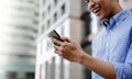 Closeup of  a Smiling Young Asian Businessman Using Mobile Phone in the City Royalty Free Stock Photo