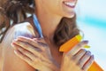 Closeup on smiling young woman applying sun block creme Royalty Free Stock Photo