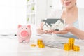 Closeup of smiling young woman holding house model Royalty Free Stock Photo