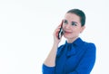 Close up of smiling young woman talking on cell phone looking to the side, over white background. Royalty Free Stock Photo