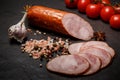 Closeup smoked ham sausage with tomatoes and garlic Royalty Free Stock Photo