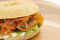 Smoked salmon bagel sandwich with cream cheese and avocado on wooden board Royalty Free Stock Photo