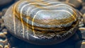 A striped river stone with air bubbles rests peacefully submerged in clear water with sunlight reflecting on its surface Royalty Free Stock Photo