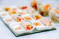 Closeup snacks at catering, banquet, buffet, finger food, shrimp, vegetable spring rolls in rice paper with peanut sauce in white Royalty Free Stock Photo