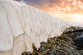 Closeup snow wall in mountain valley at the sunset