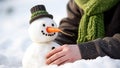 Closeup of a snowman in the hands of a young woman