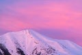 Closeup of snowy mountain peak, red sky at sunset, Pyrenees in Spain, copy space