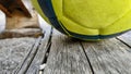 Closeup of a soccer ball on a wooden bench outdoors