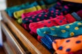 closeup of sock drawer with a mix of polka dot and solid colors