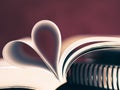 Closeup soft focus pages of a book curved into a heart shape Royalty Free Stock Photo