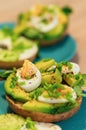 Closeup soft focus shot of avocado toast on a green plate