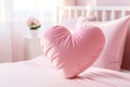 closeup soft pink heart shaped pillow on a pink bed in light bedroom Royalty Free Stock Photo