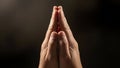 CloseUp SoftLight Human Hands Joined Together In Prayer Gesture Against Dark Background Royalty Free Stock Photo