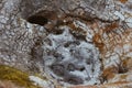 Closeup of solfatare mudpot s in the geothermal area Hverir, Iceland. The area around the boiling mud is multicolored and cracked Royalty Free Stock Photo