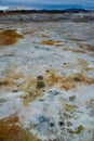 Closeup of solfatare mudpot s in the geothermal area Hverir, Iceland. The area around the boiling mud is multicolored and cracked Royalty Free Stock Photo